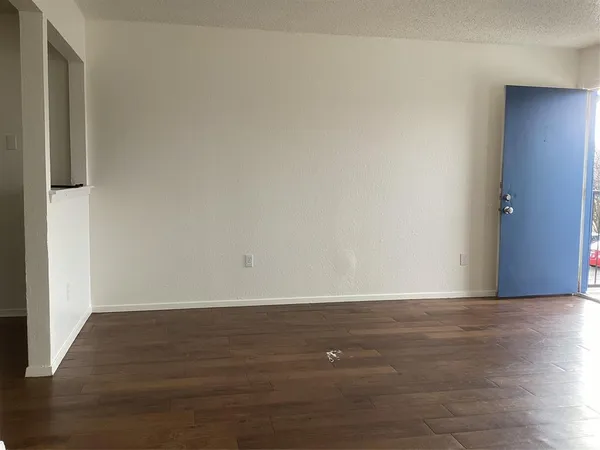 a view of room with wooden floor
