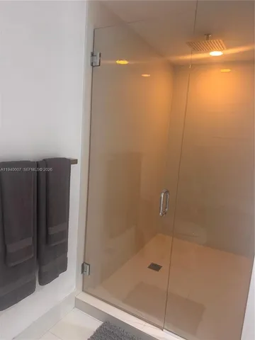 a bathroom with a glass shower door