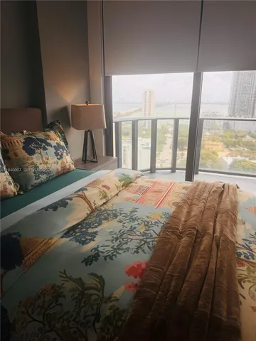 a bed sitting in a bedroom next to a window