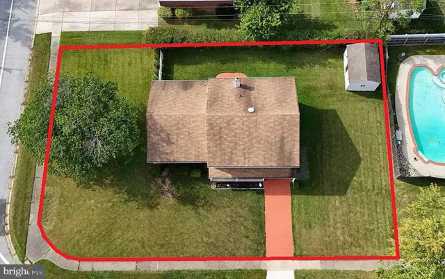 an aerial view of a house with a swimming pool