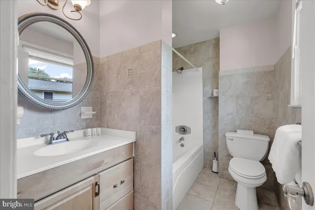 a bathroom with a sink toilet and a mirror