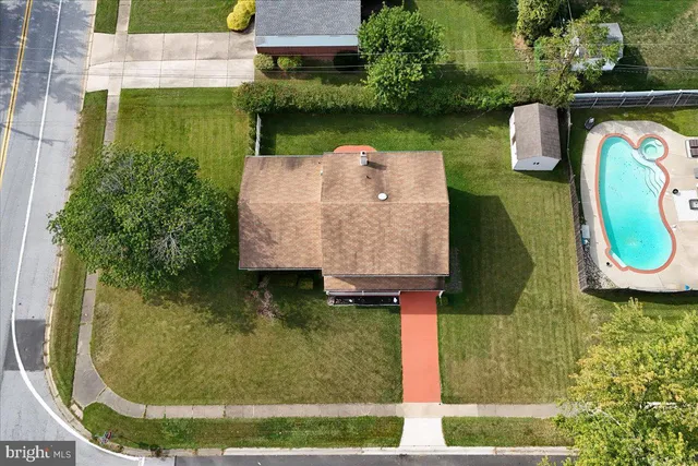 an aerial view of a house with a yard