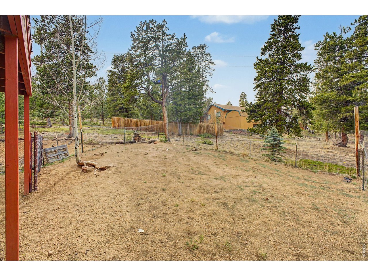 76 Highlands Drive Bailey, CO 80421 - Photo 41 of 49 a backyard of a house with table and chairs