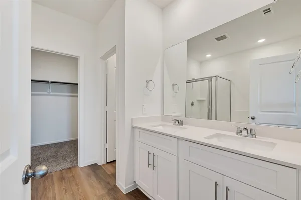 a bathroom with a sink double vanity and a mirror