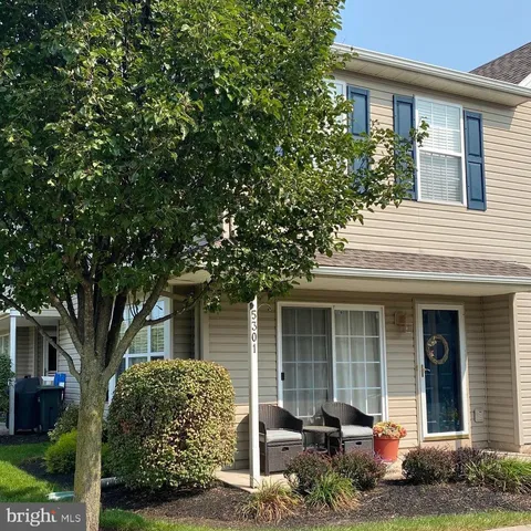a front view of a house with garden and porch