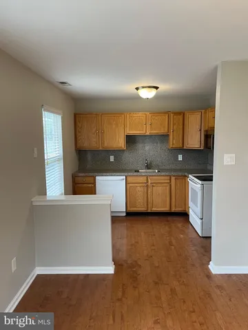 an empty room with a empty space and windows