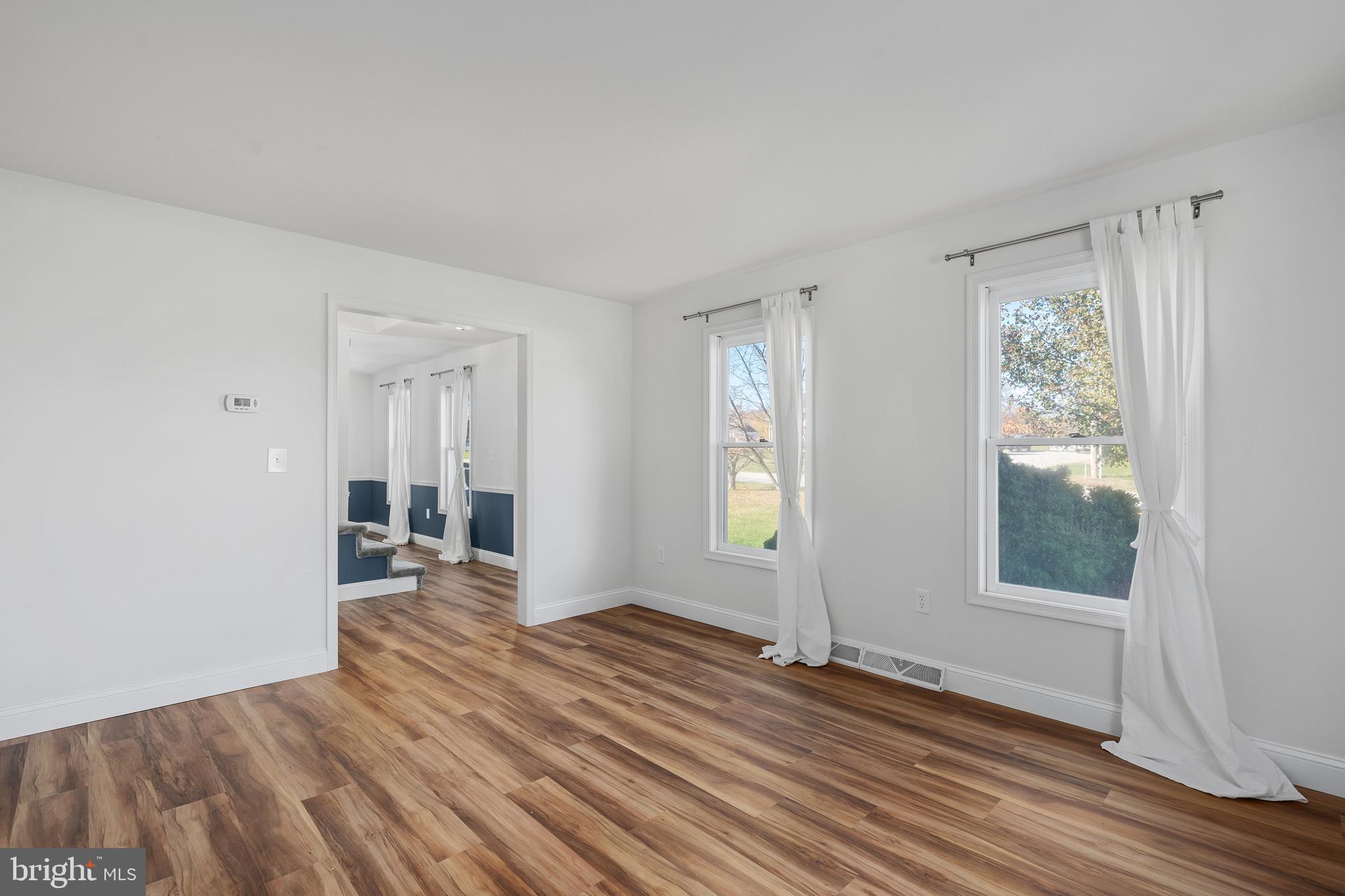 4956 East Berlin Road Thomasville, PA 17364 - Photo 11 of 31 an empty room with wooden floor and windows