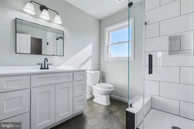 a bathroom with a toilet sink and mirror