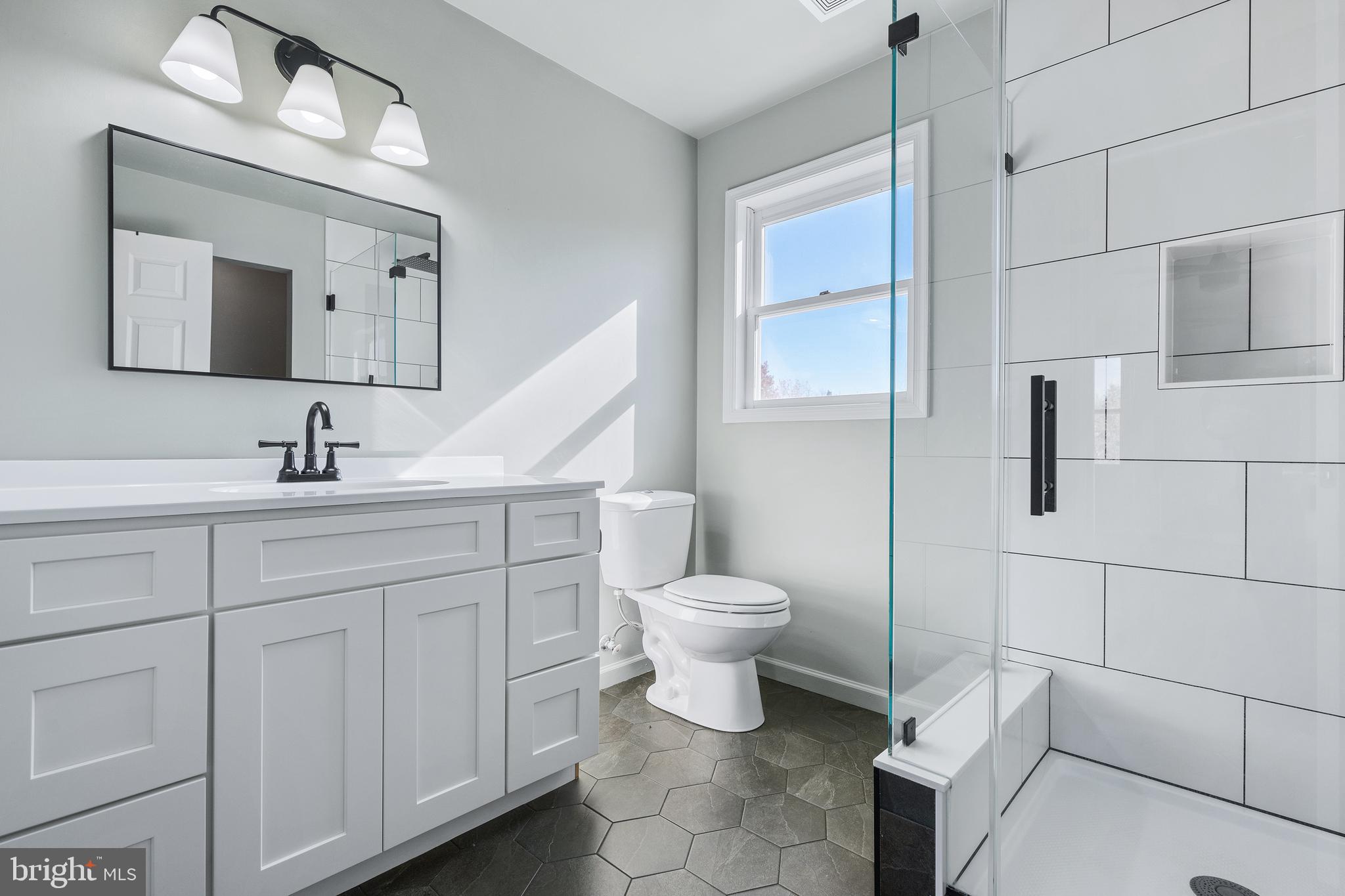 4956 East Berlin Road Thomasville, PA 17364 - Photo 17 of 31 a bathroom with a toilet sink and mirror