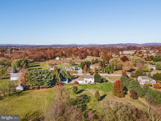 an aerial view of residential houses with city view