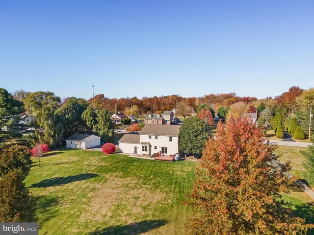 a view of a house with a yard and pool