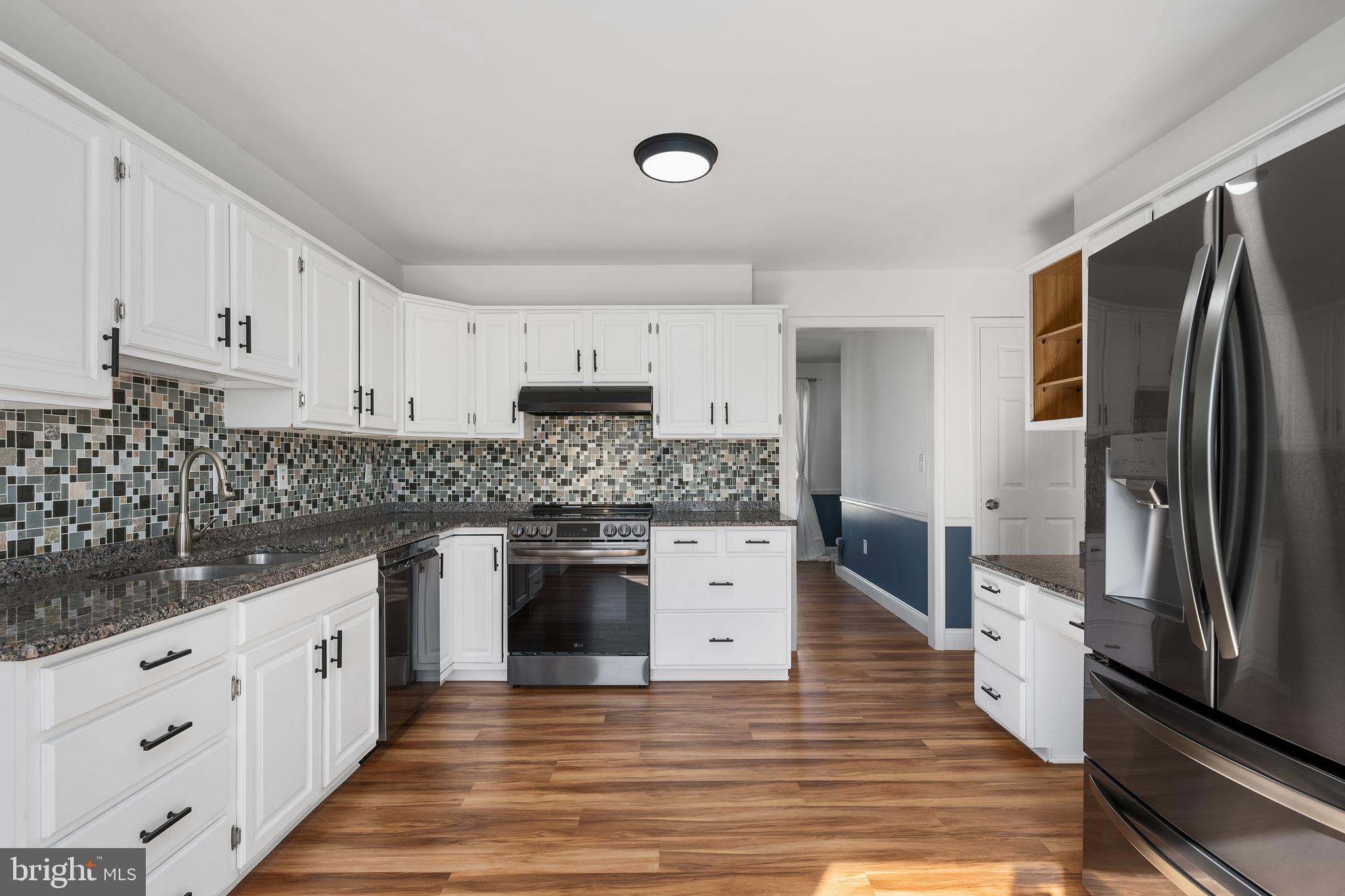4956 East Berlin Road Thomasville, PA 17364 - Photo 8 of 31 a kitchen with granite countertop a refrigerator oven a sink and dishwasher