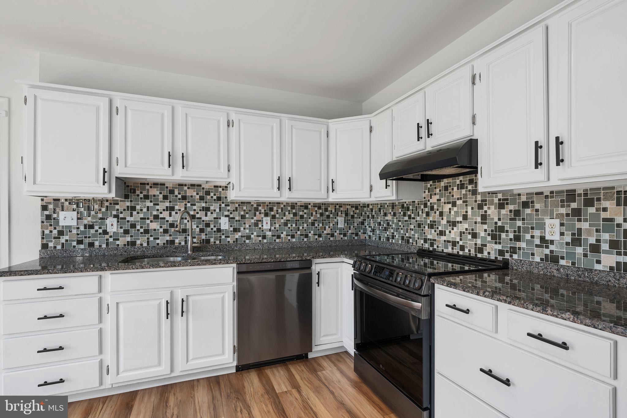 4956 East Berlin Road Thomasville, PA 17364 - Photo 9 of 31 a kitchen with white cabinets and sink