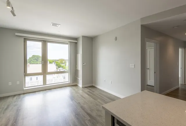 a view of a room with wooden floor and window