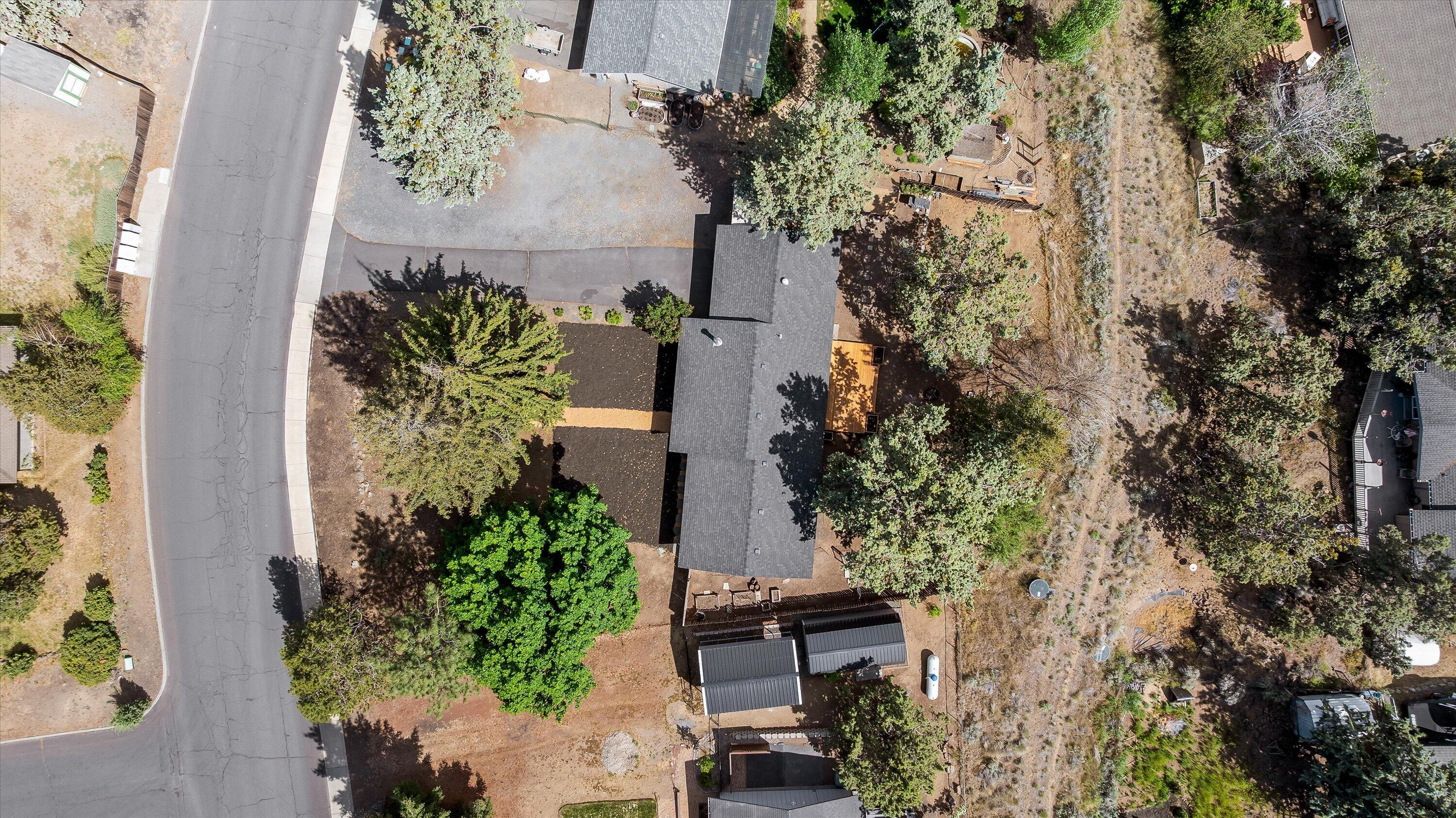 63634 Hunters Circle Bend, OR 97701 - Photo 25 of 28 an aerial view of a house with a yard and garden