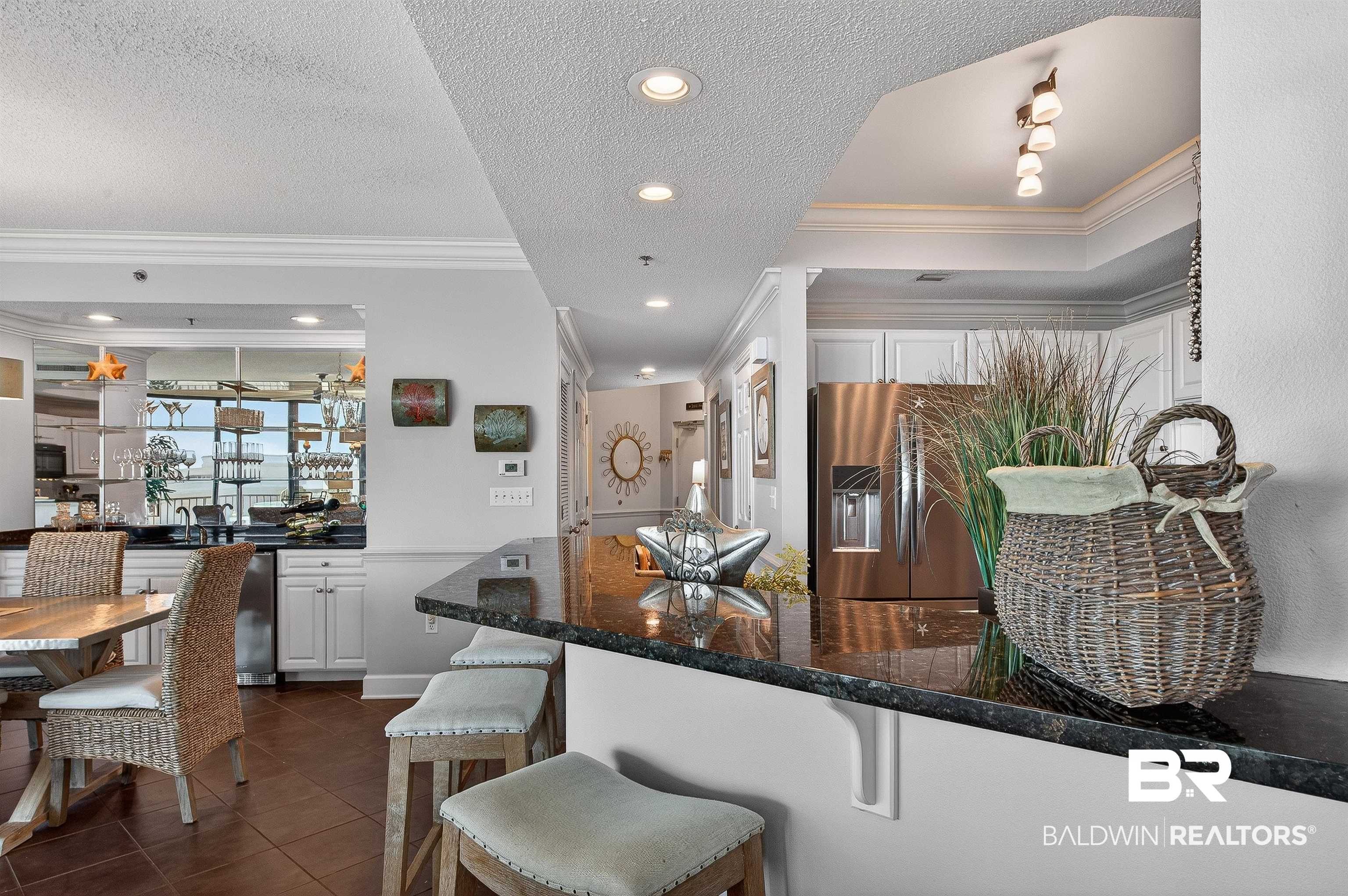 27582 Canal Road, Unit 2507 Orange Beach, AL 36561 - Photo 26 of 75 Kitchen featuring stainless steel fridge, a textured ceiling, recessed lighting, dark tile patterned floors, and white cabinetry