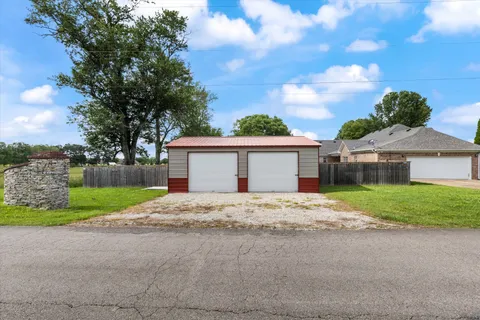 a view of large house with a yard and garage