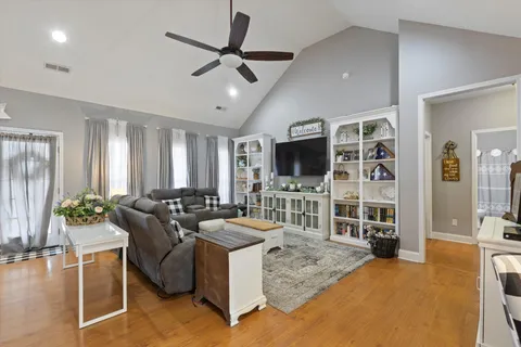 a living room with furniture a rug and a flat screen tv