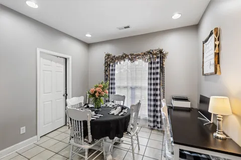 a view of a dining room with furniture and chandelier