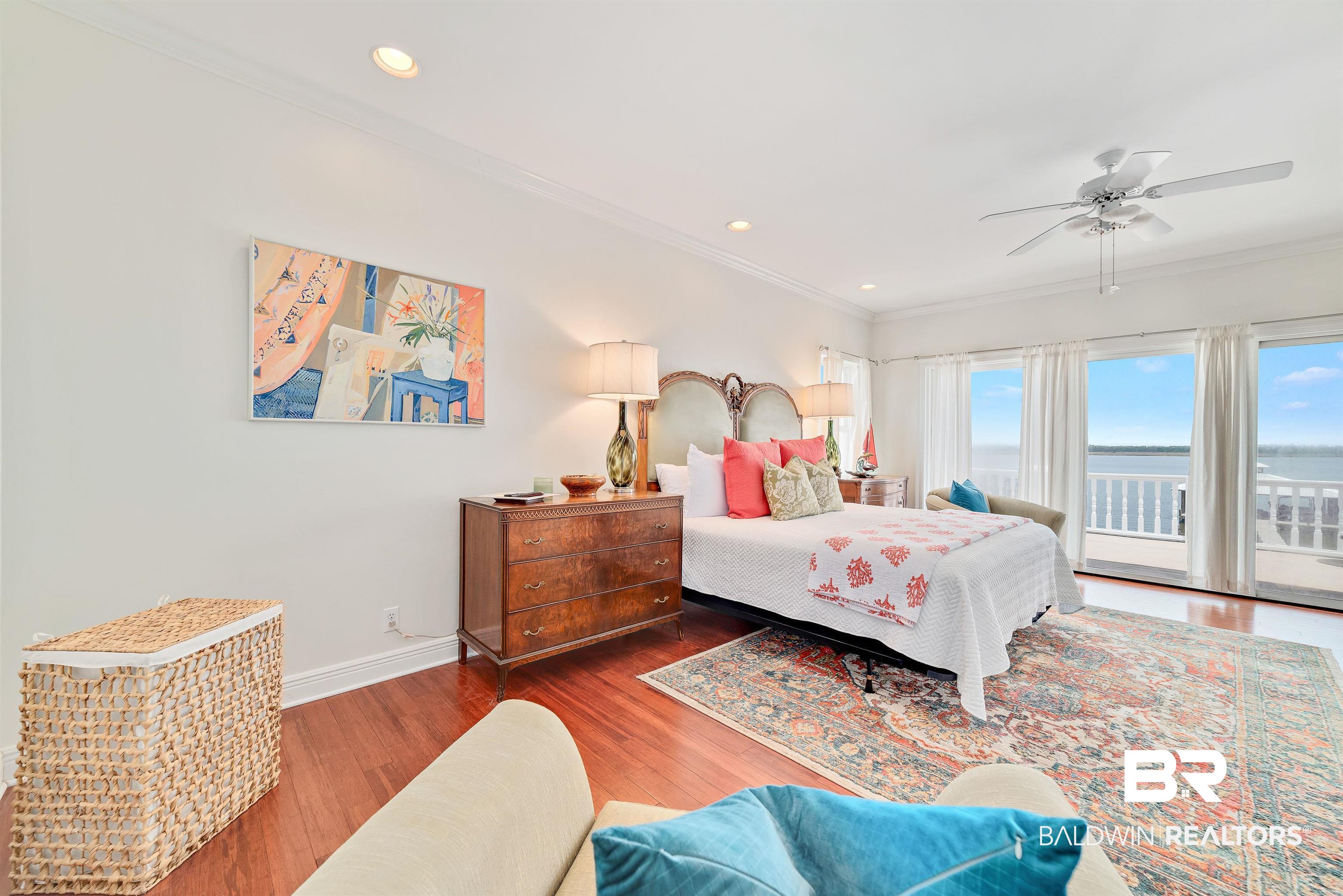24513 Gulf Bay Road Orange Beach, AL 36561 - Photo 26 of 52 Bedroom featuring access to outside, ceiling fan, hardwood / wood-style flooring, and ornamental molding