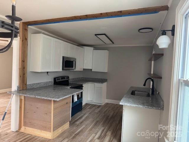509 North Ransom Street Gastonia, NC 28052 - Photo 2 of 12 a kitchen with a sink appliances and cabinets