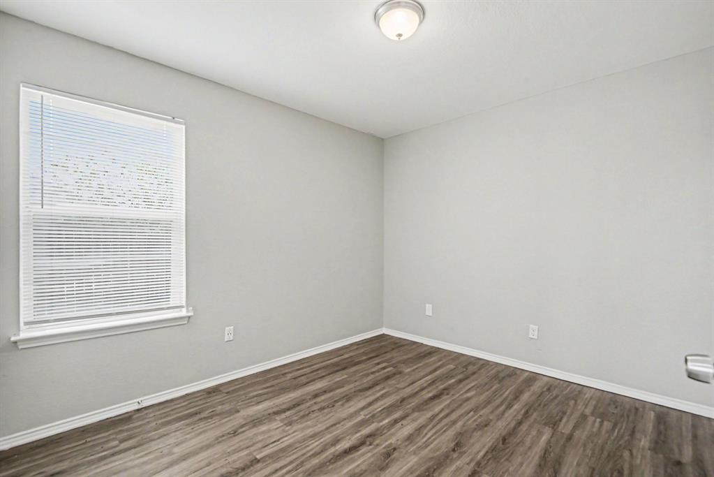 138 Kings Way Drive Rhome, TX 76078 - Photo 10 of 16 wooden floor in an empty room with a window