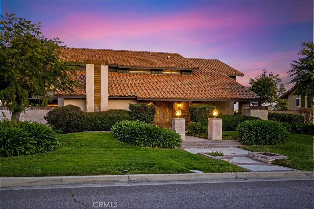 5895 Jadeite Avenue Rancho Cucamonga, CA 91737 - Photo 2 of 8 a front view of a house with a yard and garage