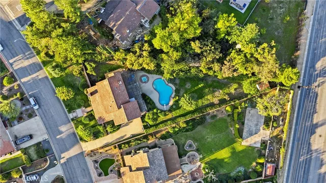 an aerial view of a house with a yard and garden