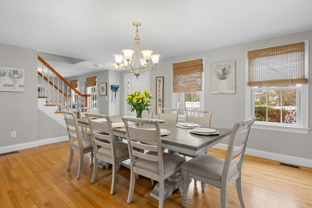 1 Anthony's Way Mashpee, MA 02649 - Photo 13 of 42 a view of a dining room with furniture a chandelier and wooden floor
