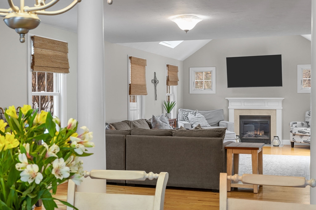 1 Anthony's Way Mashpee, MA 02649 - Photo 14 of 42 a living room with furniture a flat screen tv and a fireplace