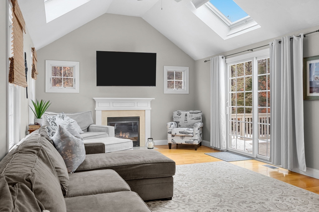 1 Anthony's Way Mashpee, MA 02649 - Photo 17 of 42 a living room with furniture a flat screen tv and a fireplace