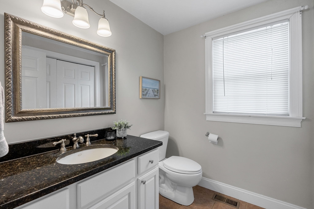 1 Anthony's Way Mashpee, MA 02649 - Photo 19 of 42 a bathroom with a granite countertop sink vanity mirror and toilet