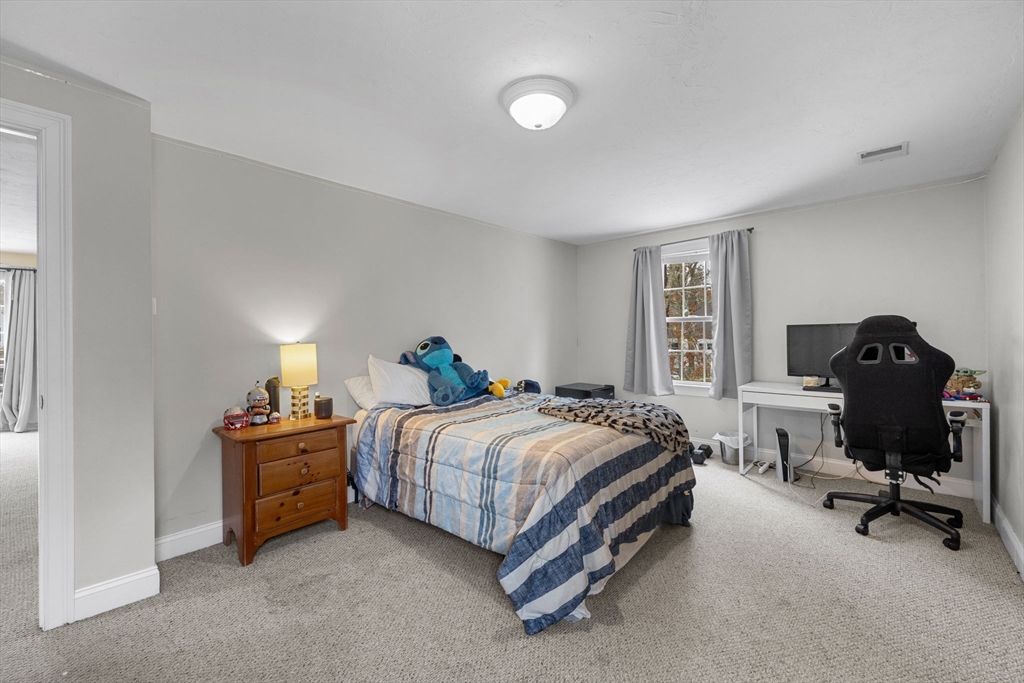 1 Anthony's Way Mashpee, MA 02649 - Photo 21 of 42 a bedroom with a bed and a chair