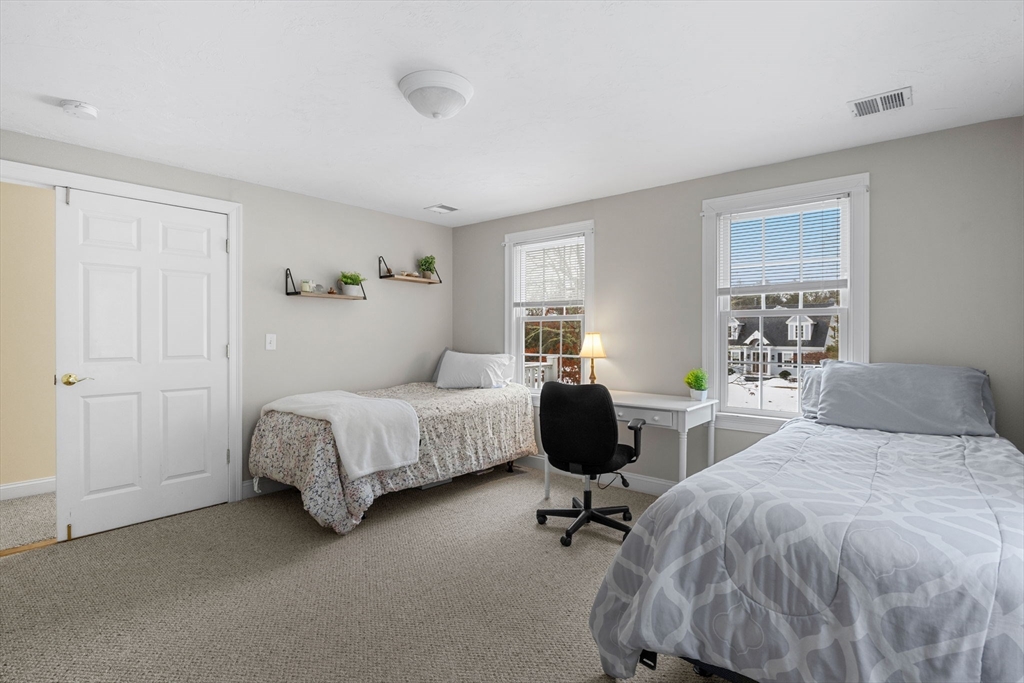 1 Anthony's Way Mashpee, MA 02649 - Photo 23 of 42 a bedroom with a bed and a table in it