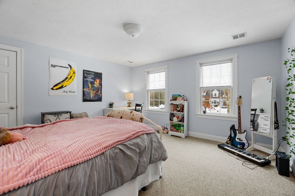1 Anthony's Way Mashpee, MA 02649 - Photo 25 of 42 a bedroom with a bed a couch and paintings on the wall