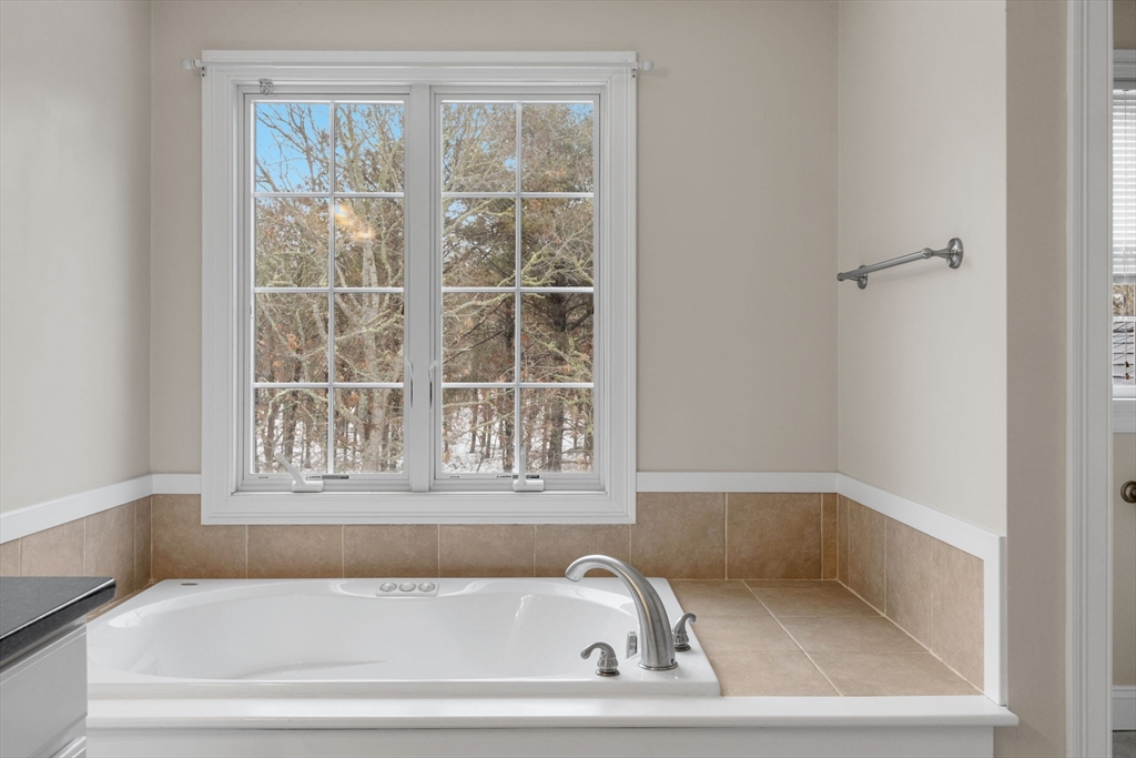 1 Anthony's Way Mashpee, MA 02649 - Photo 30 of 42 a white bath tub sitting next to a window
