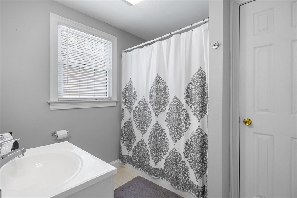 1 Anthony's Way Mashpee, MA 02649 - Photo 40 of 42 a bathroom with a shower curtain and a sink