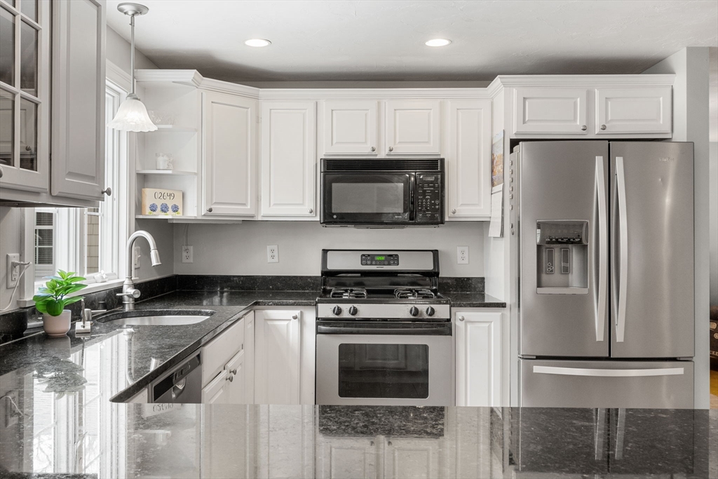 1 Anthony's Way Mashpee, MA 02649 - Photo 9 of 42 a kitchen with stainless steel appliances granite countertop a refrigerator stove microwave and sink