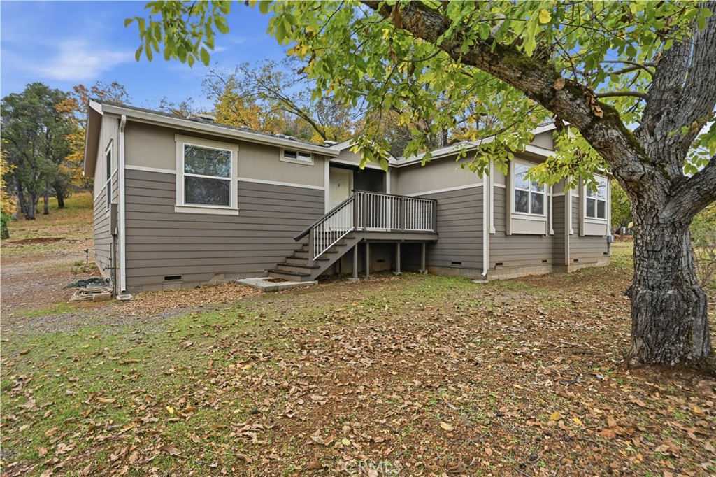 front view of a house with a large tree