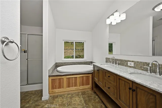 a spacious bathroom with a double vanity sink a mirror a and a window