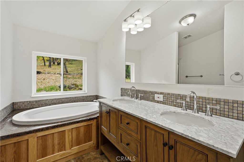 13035 Anderson Road Lower Lake, CA 95457 - Photo 17 of 39 a bathroom with a granite countertop sink a toilet and bathtub