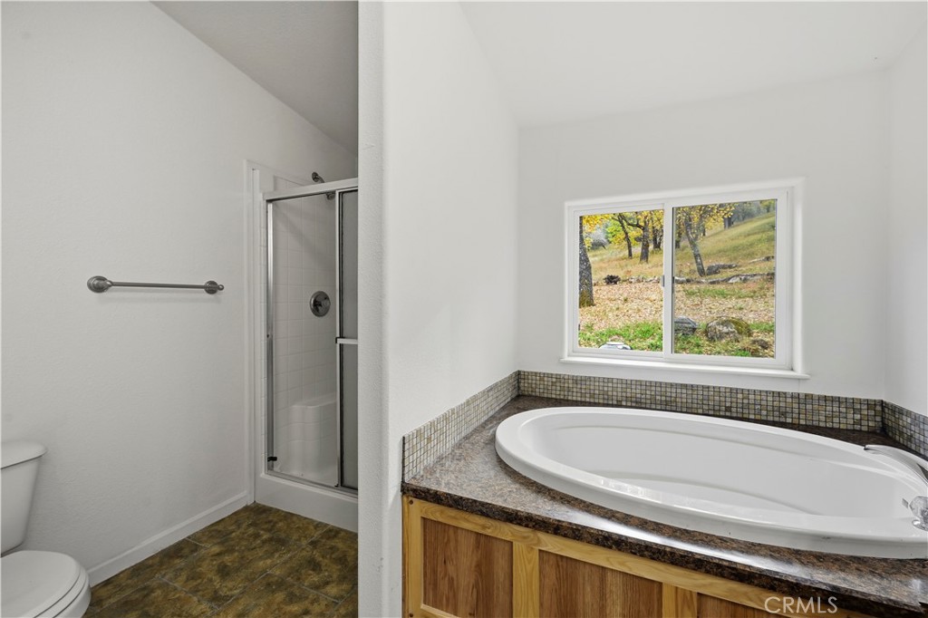 13035 Anderson Road Lower Lake, CA 95457 - Photo 18 of 39 a bathroom with a granite countertop sink and a mirror