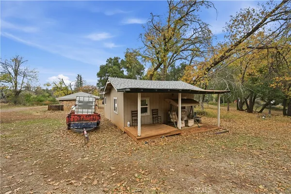 a front view of a house with a yard and trees