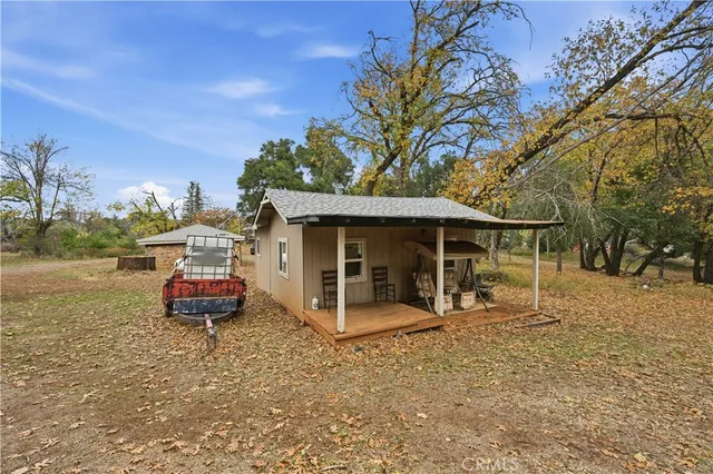 a front view of a house with a yard and trees