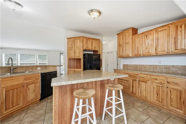 a kitchen with stainless steel appliances granite countertop a stove top oven a sink and dishwasher