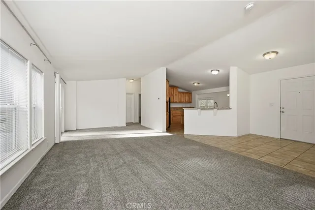 a view of a big room with wooden cabinet and windows