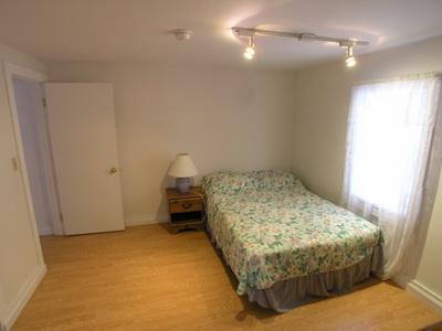 188 Captain Chase Road Dennis Port, MA 02639 - Photo 11 of 14 a bedroom with a bed and a chandelier