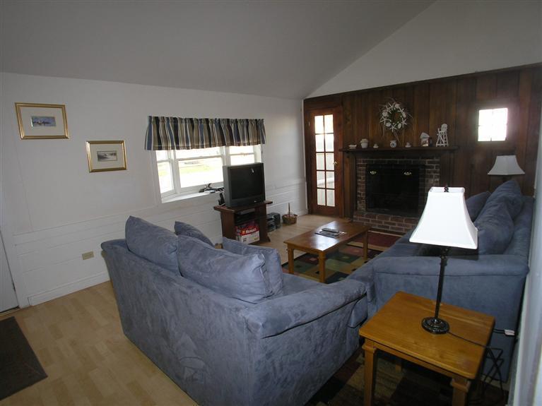 188 Captain Chase Road Dennis Port, MA 02639 - Photo 6 of 14 a living room with furniture and a lamp