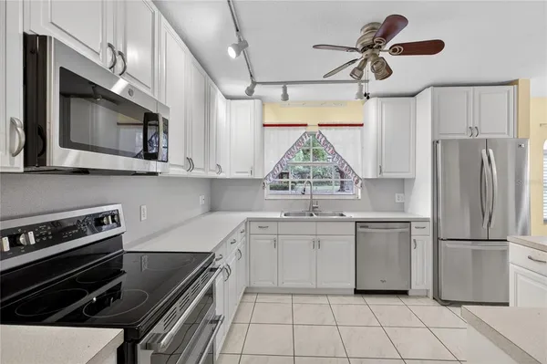 a kitchen with stainless steel appliances a stove sink and microwave