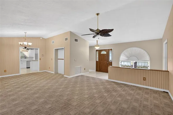 a view of a kitchen with a sink and a chandelier